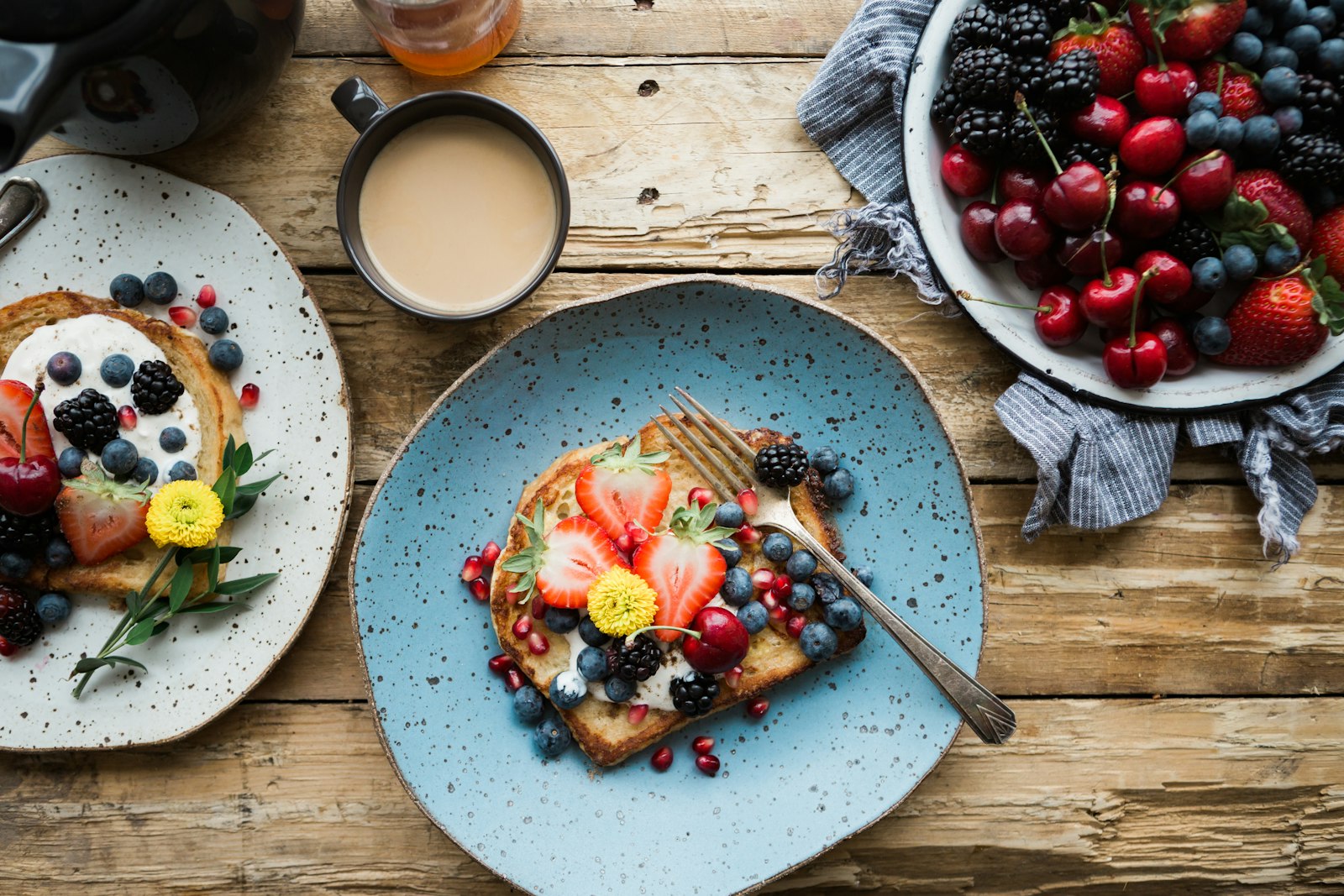 The breakfast table laid with fruit, coffee and French toast