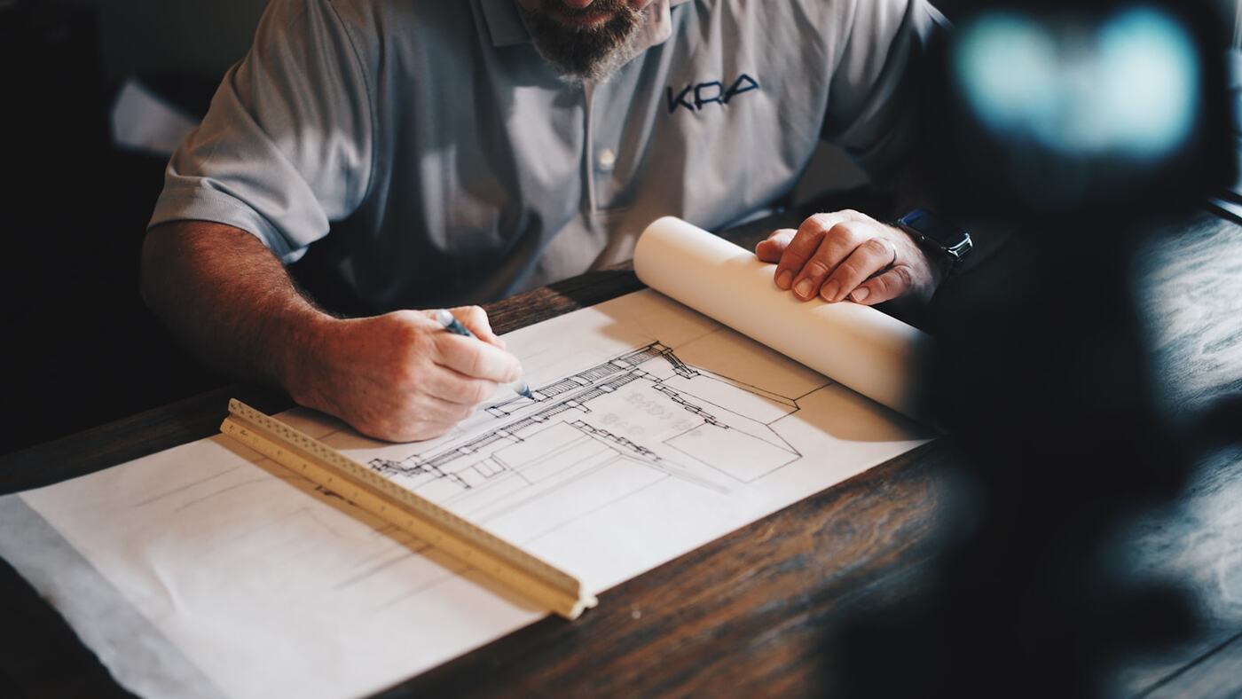 Ray marking up survey drawings at the yard