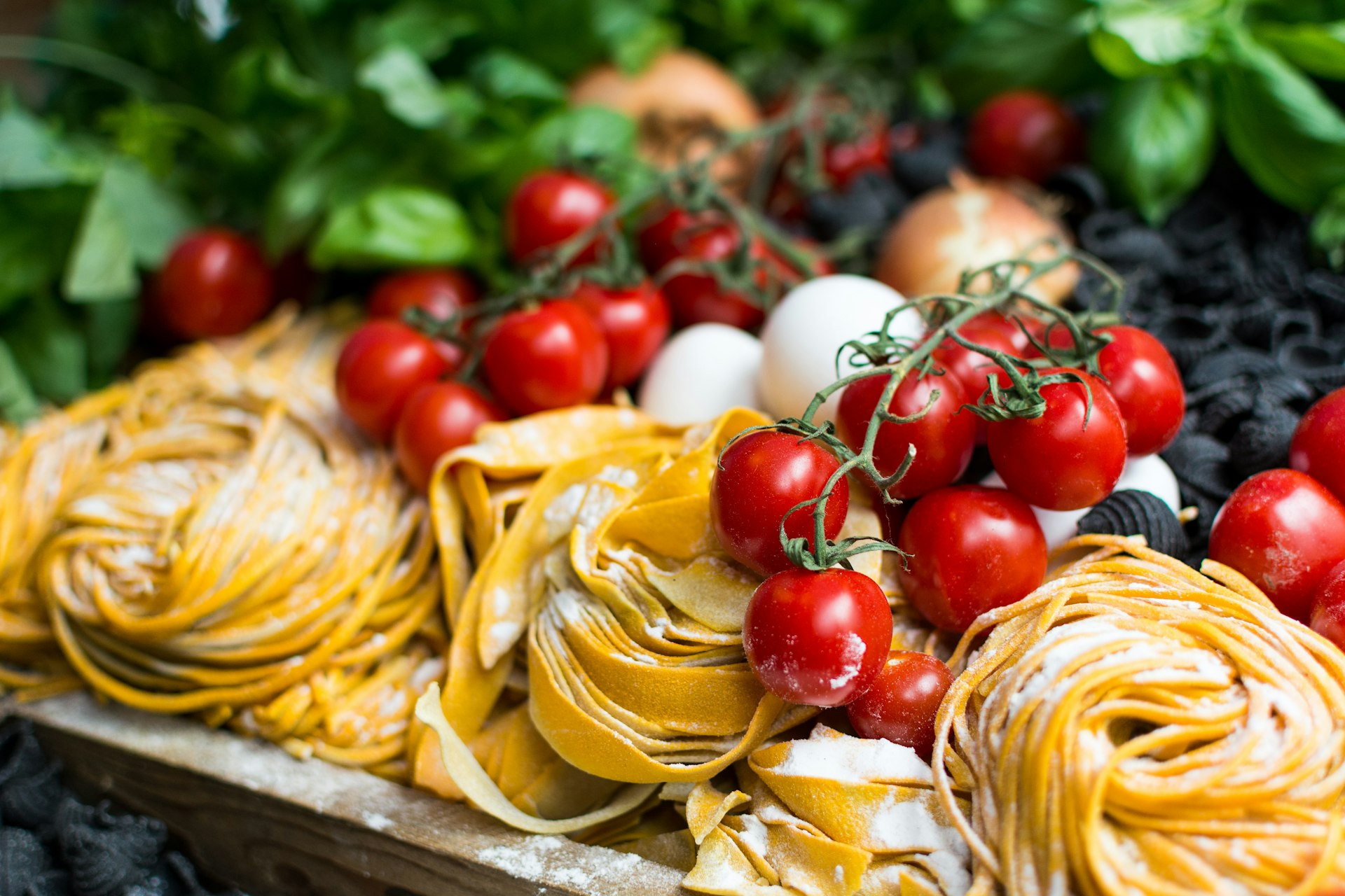 Fresh tagliatelle, vine tomatoes and basil on the pass at Osteria Fiamma