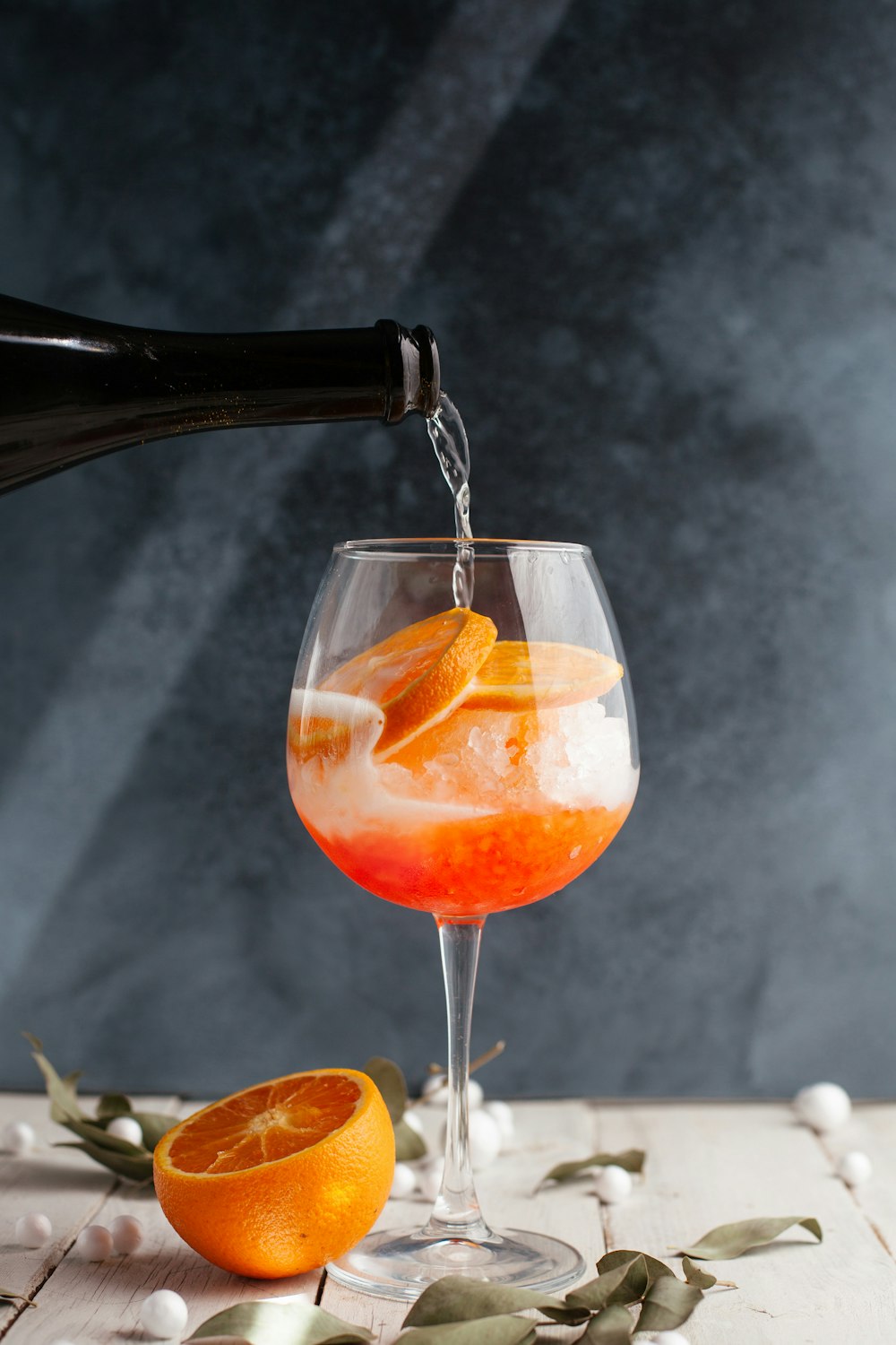A spritz being poured over ice