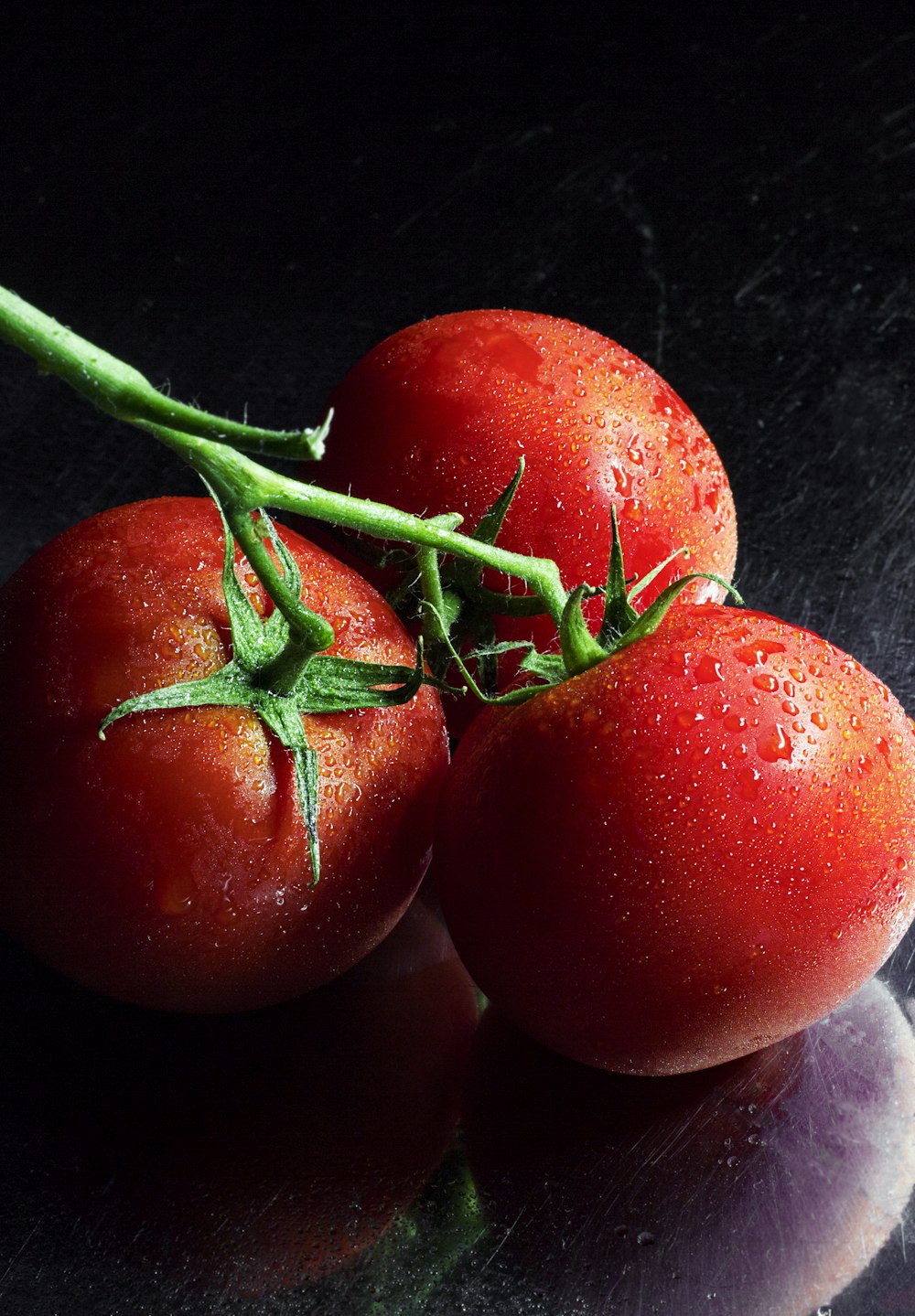 Vine tomatoes on a dark counter