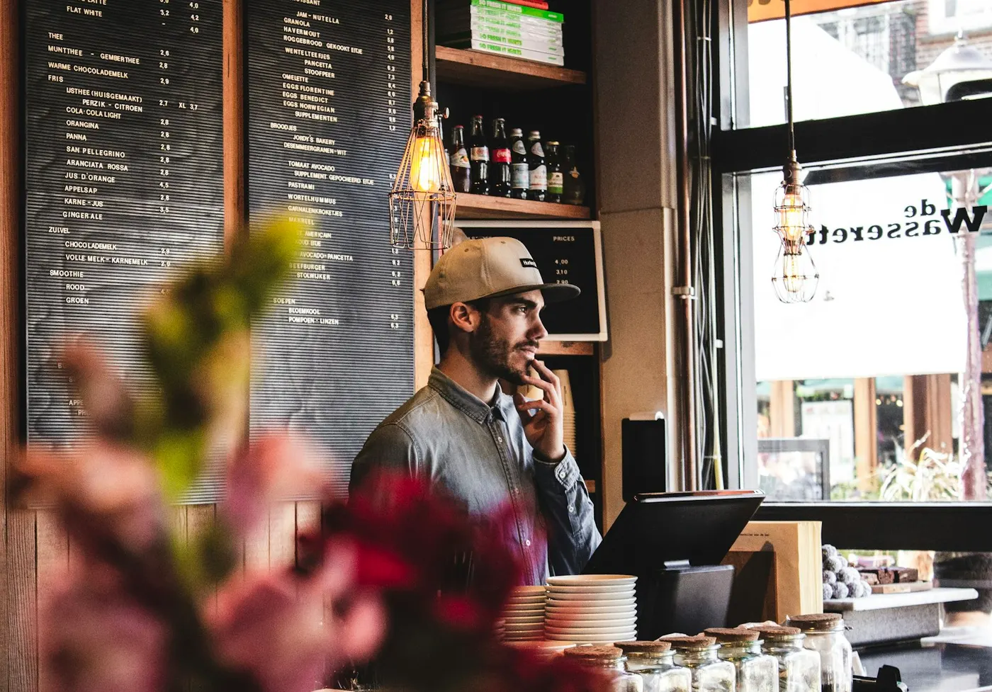 The owner of a small cafe behind the counter, the kind of local business that wins customers through social media