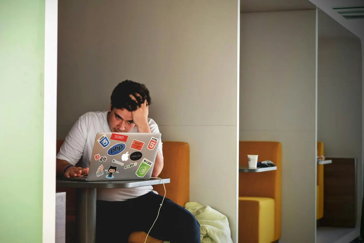 A person looking frustrated at a laptop, the feeling of a website that quietly loses customers